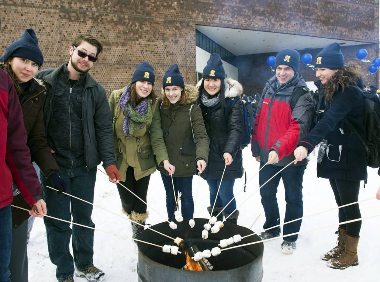 Students roast marshmallows during Winterfest tradition at the University of Rochester