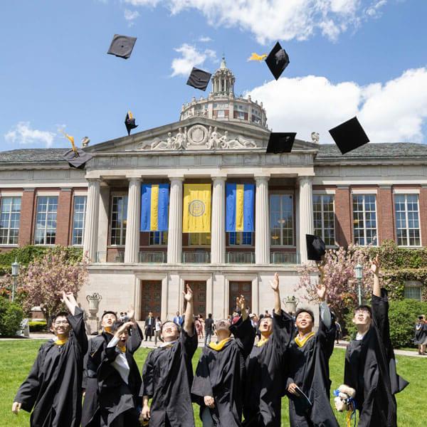 Students toss ther graduation caps in the air after the University of Rochester Commencement Weekend.